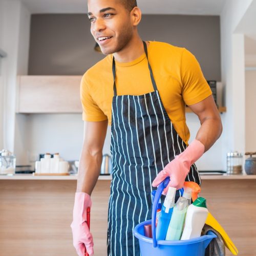 latin-man-holding-a-bucket-with-cleaning-items-.jpg